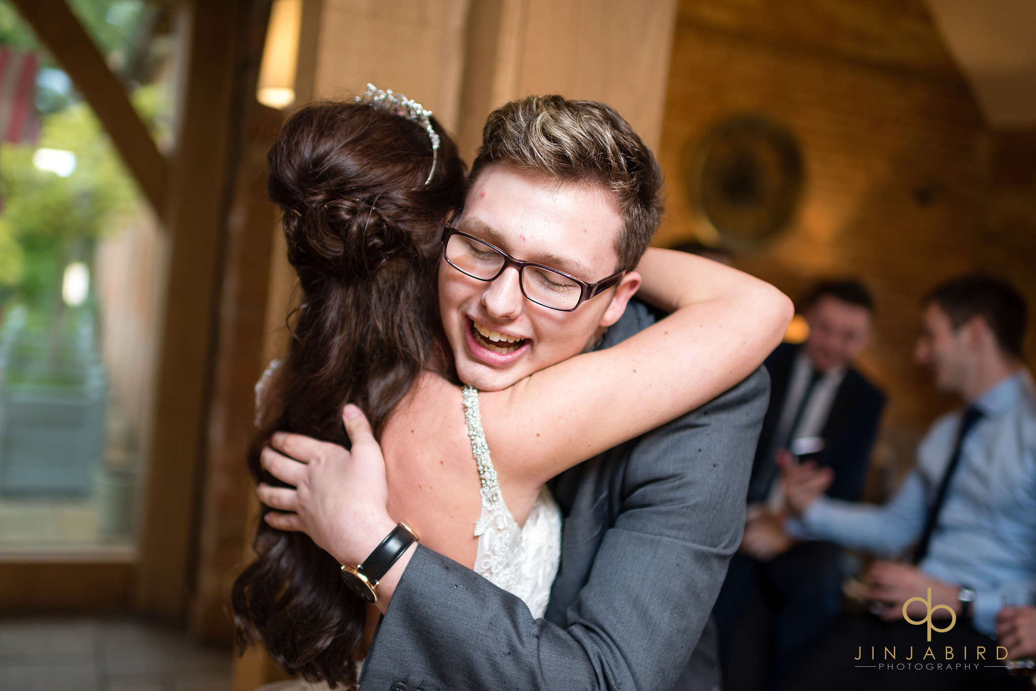 guest hugging bride